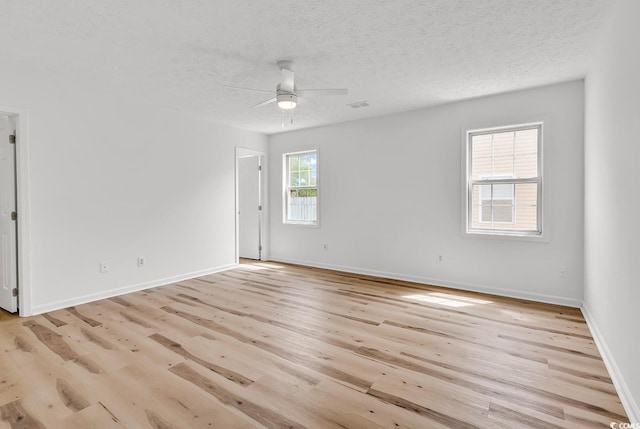 9616 Sullivan Dr, Murrells Inlet, SC 29576 - unfurnished room with ceiling fan, light wood-style floors, a textured ceiling, baseboards, and visible vents