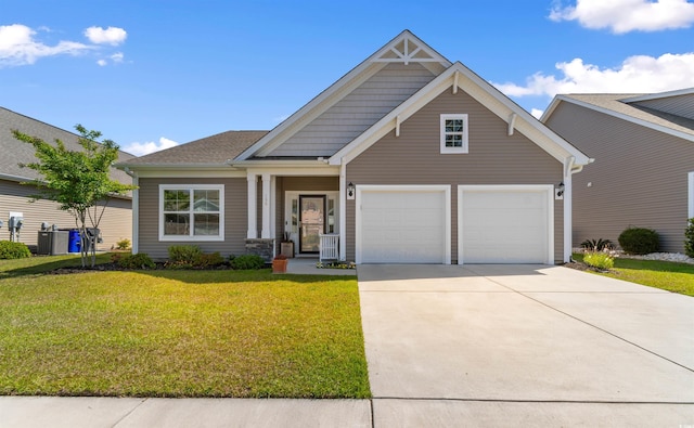 craftsman inspired home featuring concrete driveway, a front yard, central AC unit, and an attached garage