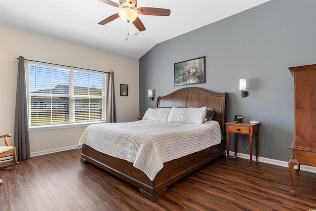 bedroom featuring baseboards, wood finished floors, lofted ceiling, and a ceiling fan