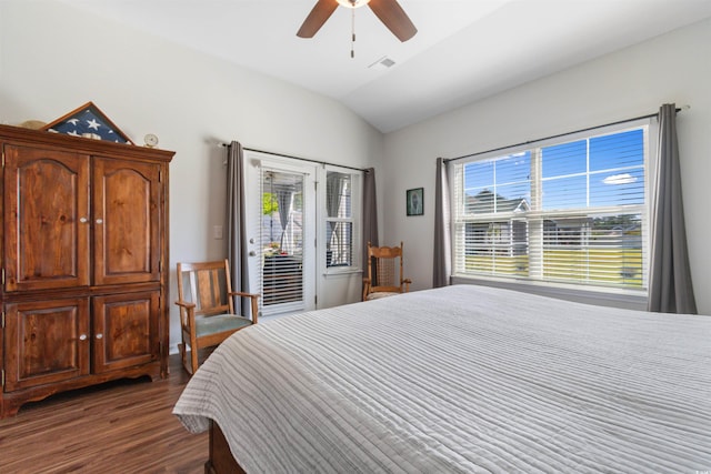 bedroom featuring dark wood finished floors, lofted ceiling, multiple windows, access to exterior, and ceiling fan
