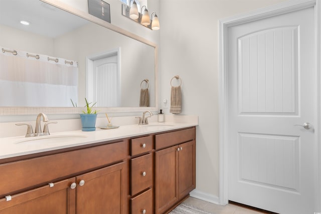 bathroom with tile patterned floors and double vanity