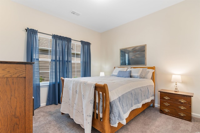 bedroom with carpet floors and baseboards