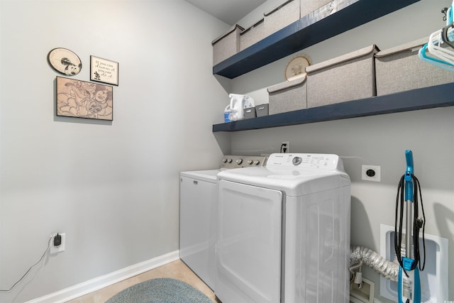 laundry area featuring washing machine and clothes dryer and baseboards