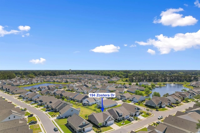 aerial perspective of suburban area featuring a nearby body of water