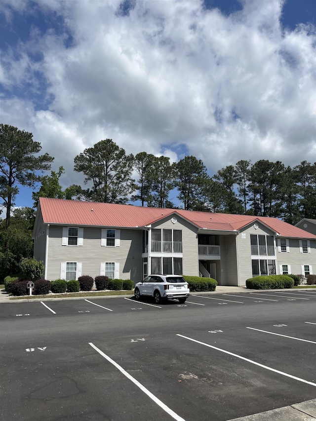 view of property featuring uncovered parking