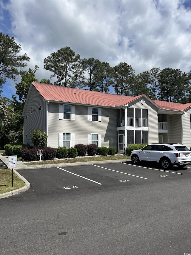 view of property featuring uncovered parking