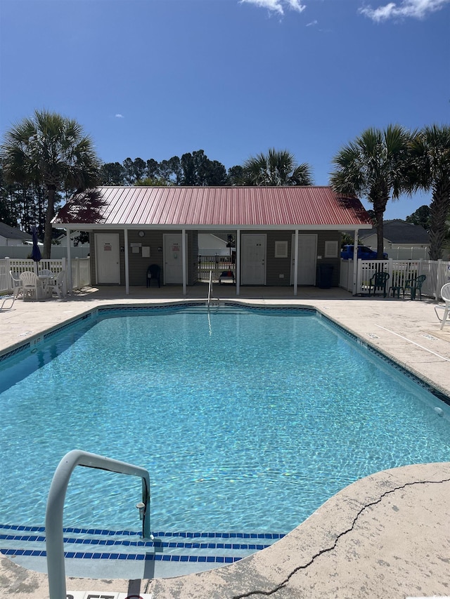 pool with a sink, fence, and a patio area