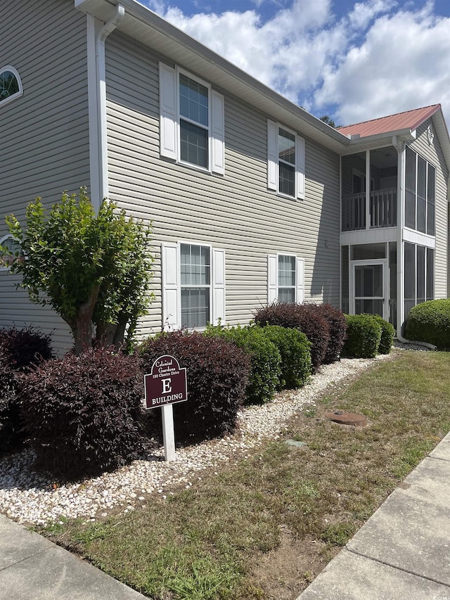view of side of property featuring metal roof