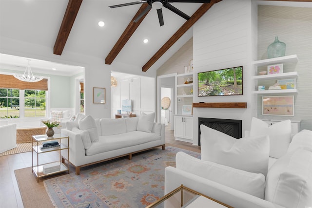 living room featuring recessed lighting, beam ceiling, wood finished floors, and ceiling fan with notable chandelier