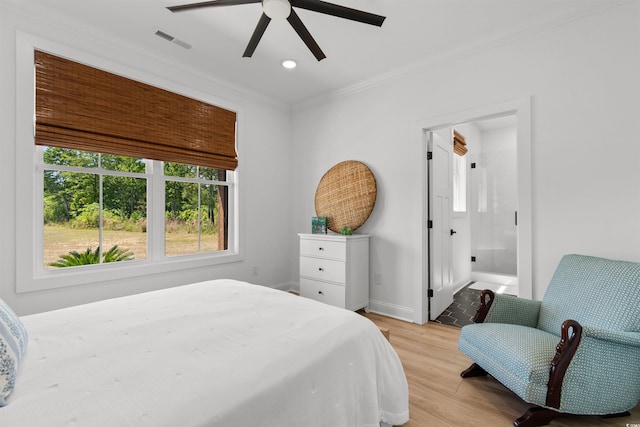 bedroom with visible vents, ornamental molding, light wood-style flooring, and multiple windows