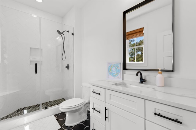 bathroom featuring toilet, tile patterned floors, a shower stall, and vanity