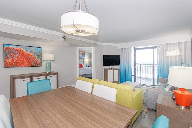 dining space featuring crown molding and visible vents