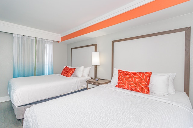 bedroom featuring baseboards and wood finished floors