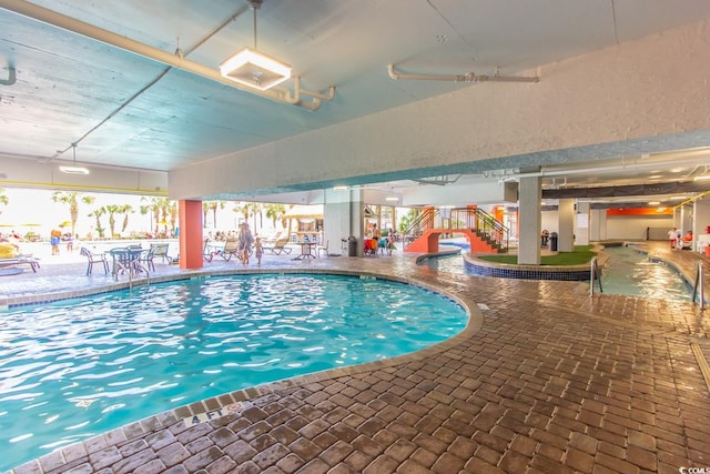 pool with stairs and a patio area