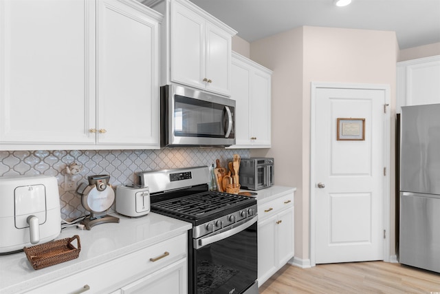 315 Cattle Drive Cir, Myrtle Beach, SC 29588 - kitchen with stainless steel appliances, light countertops, white cabinets, decorative backsplash, and recessed lighting