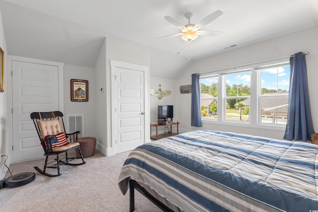 carpeted bedroom featuring ceiling fan, visible vents, baseboards, and lofted ceiling