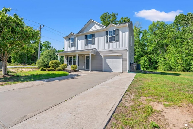 traditional home featuring covered porch, an attached garage, driveway, a front lawn, and board and batten siding