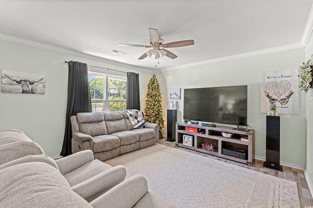 living room featuring crown molding, a ceiling fan, wood finished floors, and baseboards