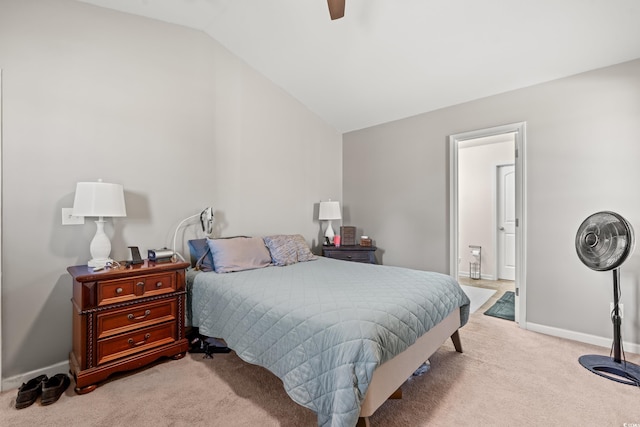carpeted bedroom with vaulted ceiling, baseboards, and ceiling fan