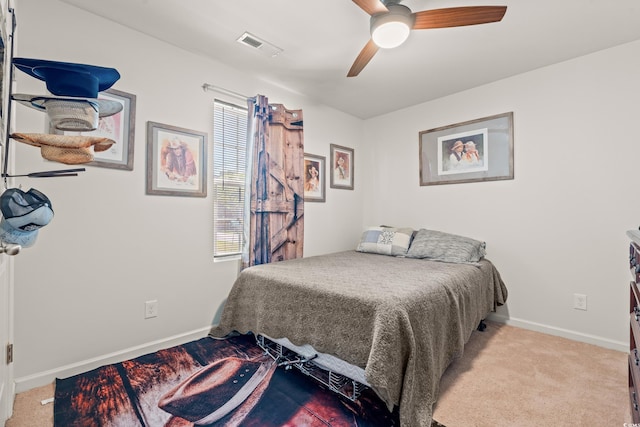 carpeted bedroom featuring baseboards and a ceiling fan