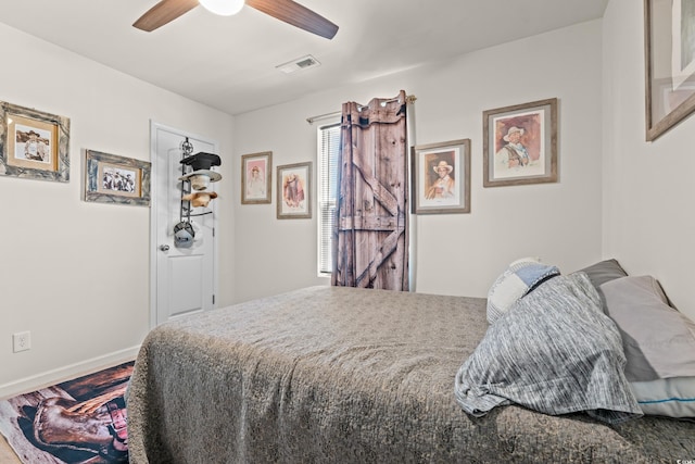 bedroom with baseboards, a ceiling fan, and wood finished floors