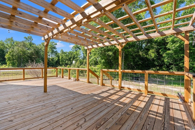 deck featuring a pergola and view of scattered trees