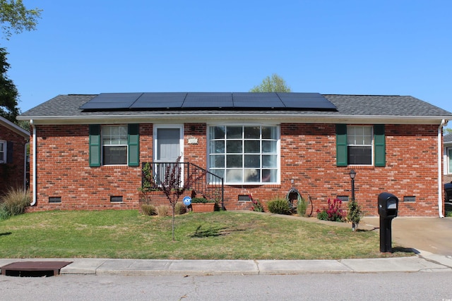 ranch-style house featuring crawl space, roof mounted solar panels, and a front yard