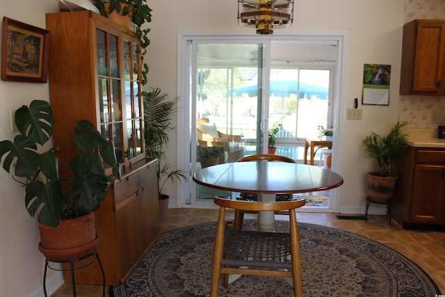 dining room featuring baseboards and a chandelier