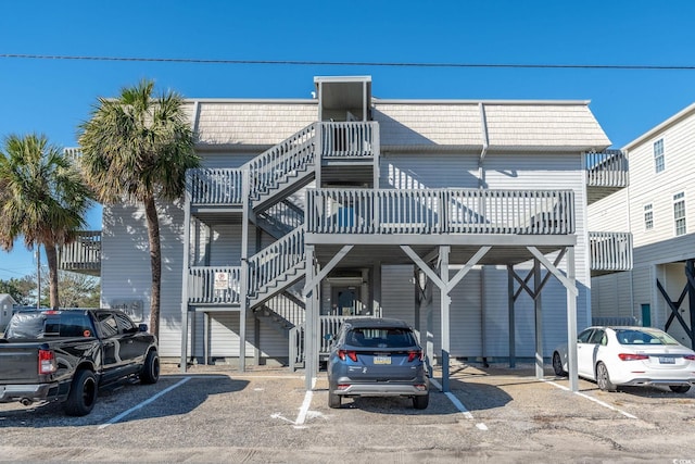 300 47th Ave S Unit 1E, North Myrtle Beach, SC 29582 - view of property with stairway and uncovered parking