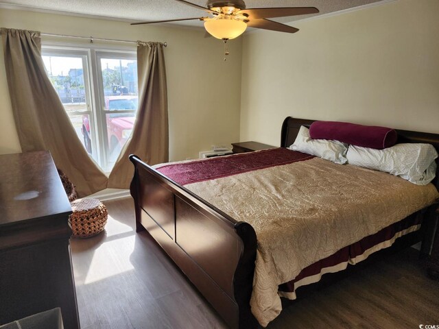 300 47th Ave S Unit 1E, North Myrtle Beach, SC 29582 - bedroom with wood finished floors and ceiling fan