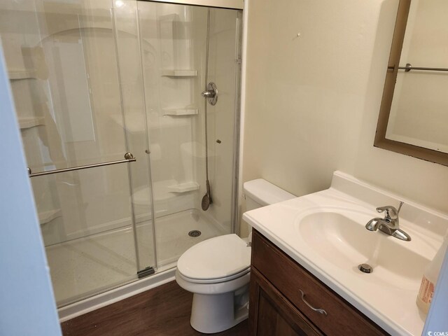 300 47th Ave S Unit 1E, North Myrtle Beach, SC 29582 - bathroom featuring a stall shower, toilet, wood finished floors, and vanity