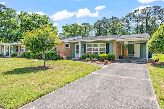 558 Juniper Dr -, Unit Myrtle Beach, SC 29577 - single story home featuring driveway, an attached carport, brick siding, and a front lawn