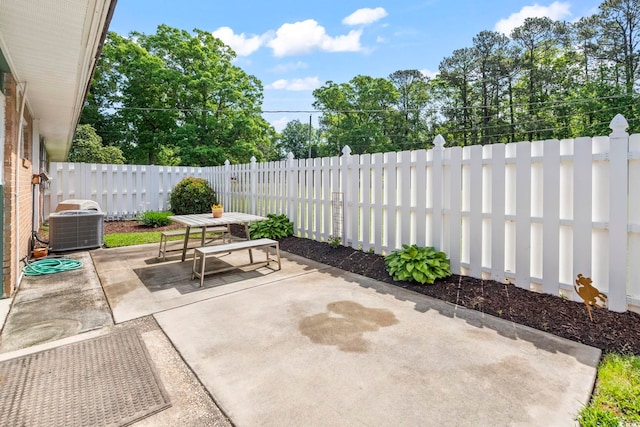 558 Juniper Dr -, Unit Myrtle Beach, SC 29577 - view of patio / terrace with a fenced backyard, outdoor dining space, and central AC