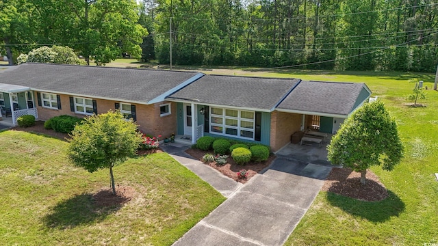 558 Juniper Dr -, Unit Myrtle Beach, SC 29577 - view of front of home featuring an attached carport, a front lawn, a shingled roof, brick siding, and driveway