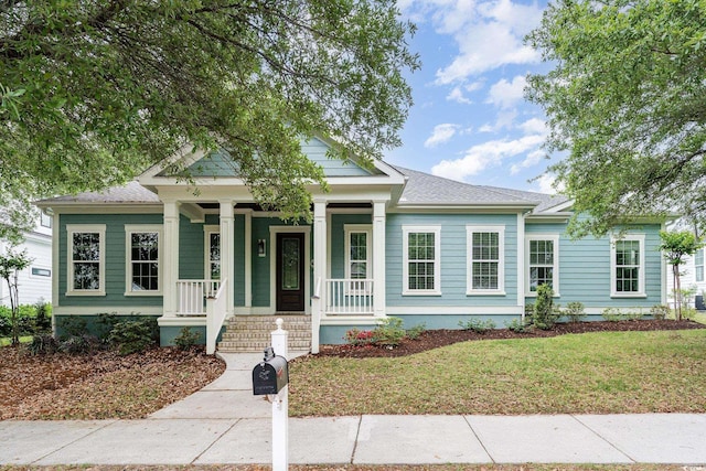 1400 James Island Ave, North Myrtle Beach, SC 29582 - view of front of house featuring a porch and a front lawn