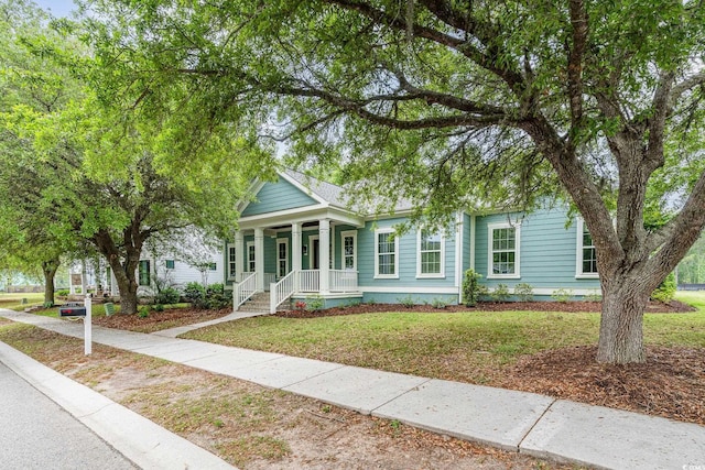 1400 James Island Ave, North Myrtle Beach, SC 29582 - view of front facade with covered porch and a front yard