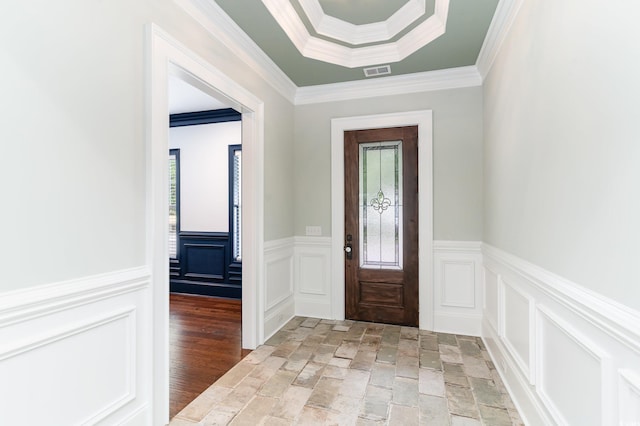 1400 James Island Ave, North Myrtle Beach, SC 29582 - entrance foyer with stone tile floors, a decorative wall, a wainscoted wall, and crown molding