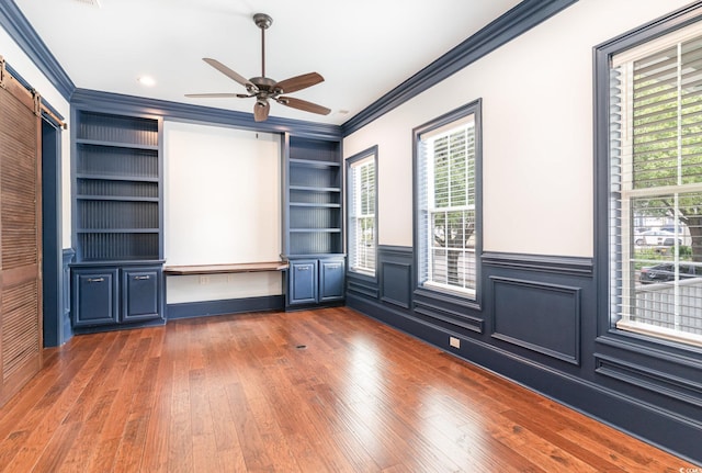 1400 James Island Ave, North Myrtle Beach, SC 29582 - spare room with ornamental molding, built in features, hardwood / wood-style floors, wainscoting, and a ceiling fan