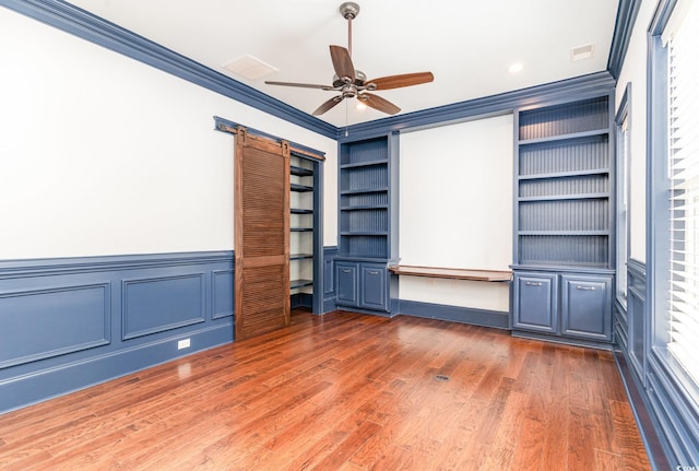 1400 James Island Ave, North Myrtle Beach, SC 29582 - unfurnished bedroom featuring crown molding, wood finished floors, a wainscoted wall, a ceiling fan, and recessed lighting