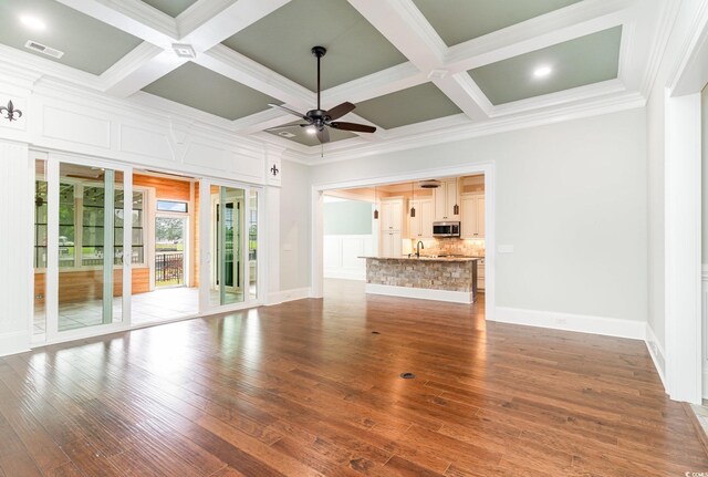 1400 James Island Ave, North Myrtle Beach, SC 29582 - unfurnished living room featuring a ceiling fan, a sink, coffered ceiling, ornamental molding, and wood finished floors