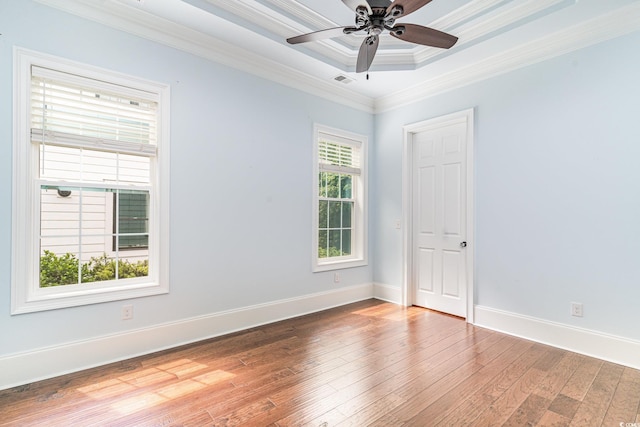 1400 James Island Ave, North Myrtle Beach, SC 29582 - spare room featuring hardwood / wood-style floors, a ceiling fan, ornamental molding, baseboards, and a tray ceiling