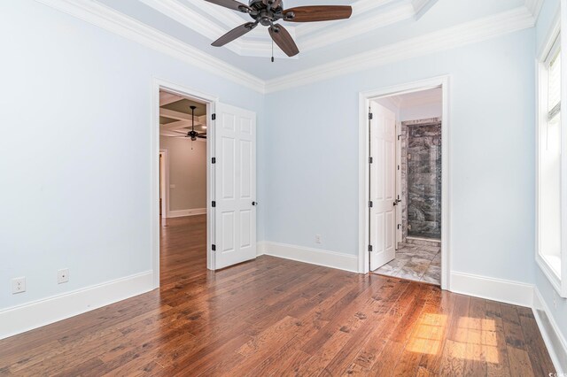 1400 James Island Ave, North Myrtle Beach, SC 29582 - unfurnished bedroom featuring crown molding, wood-type flooring, a walk in closet, and baseboards