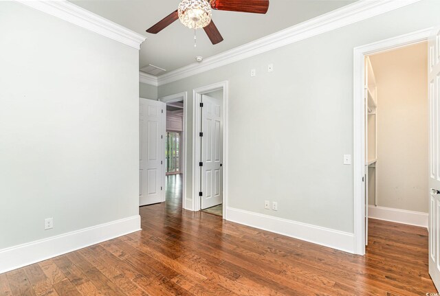 1400 James Island Ave, North Myrtle Beach, SC 29582 - unfurnished bedroom featuring crown molding, baseboards, wood finished floors, and ceiling fan