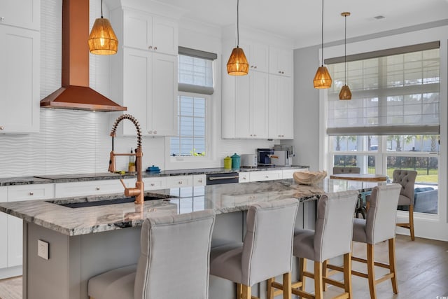 260 Palmetto Harbour Dr, North Myrtle Beach, SC 29582 - kitchen with wall chimney range hood, decorative backsplash, white cabinetry, and a sink