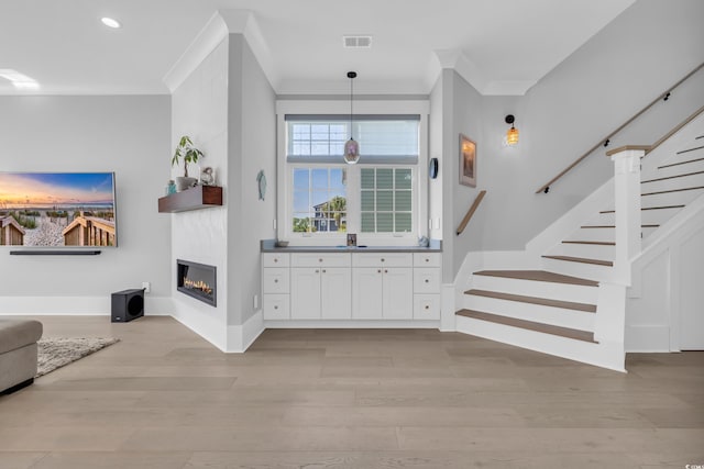 260 Palmetto Harbour Dr, North Myrtle Beach, SC 29582 - living area with visible vents, ornamental molding, stairway, a large fireplace, and light wood-style flooring