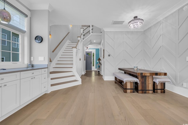 260 Palmetto Harbour Dr, North Myrtle Beach, SC 29582 - entryway featuring a notable chandelier, light wood finished floors, a decorative wall, visible vents, and stairway