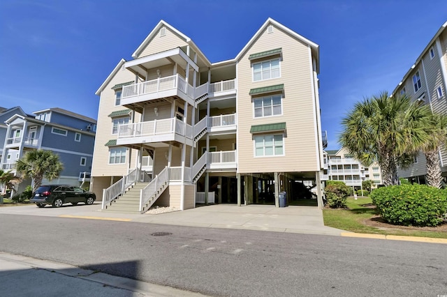 view of building exterior featuring driveway and a carport