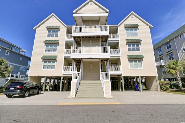 156 Via Old Sound Blvd Unit C, Ocean Isle Beach, NC 28469 - view of property featuring concrete driveway, stairs, and a carport