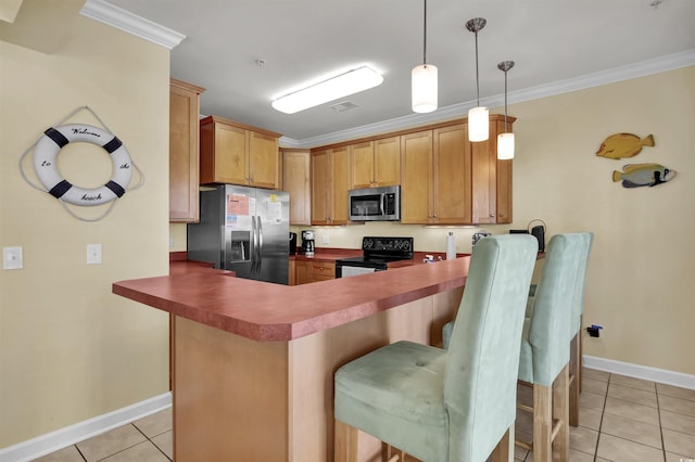 kitchen featuring appliances with stainless steel finishes, light tile patterned floors, baseboards, a peninsula, and a breakfast bar