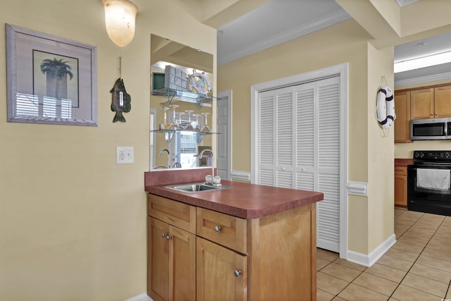 interior space featuring crown molding, black electric range oven, stainless steel microwave, a sink, and light tile patterned floors